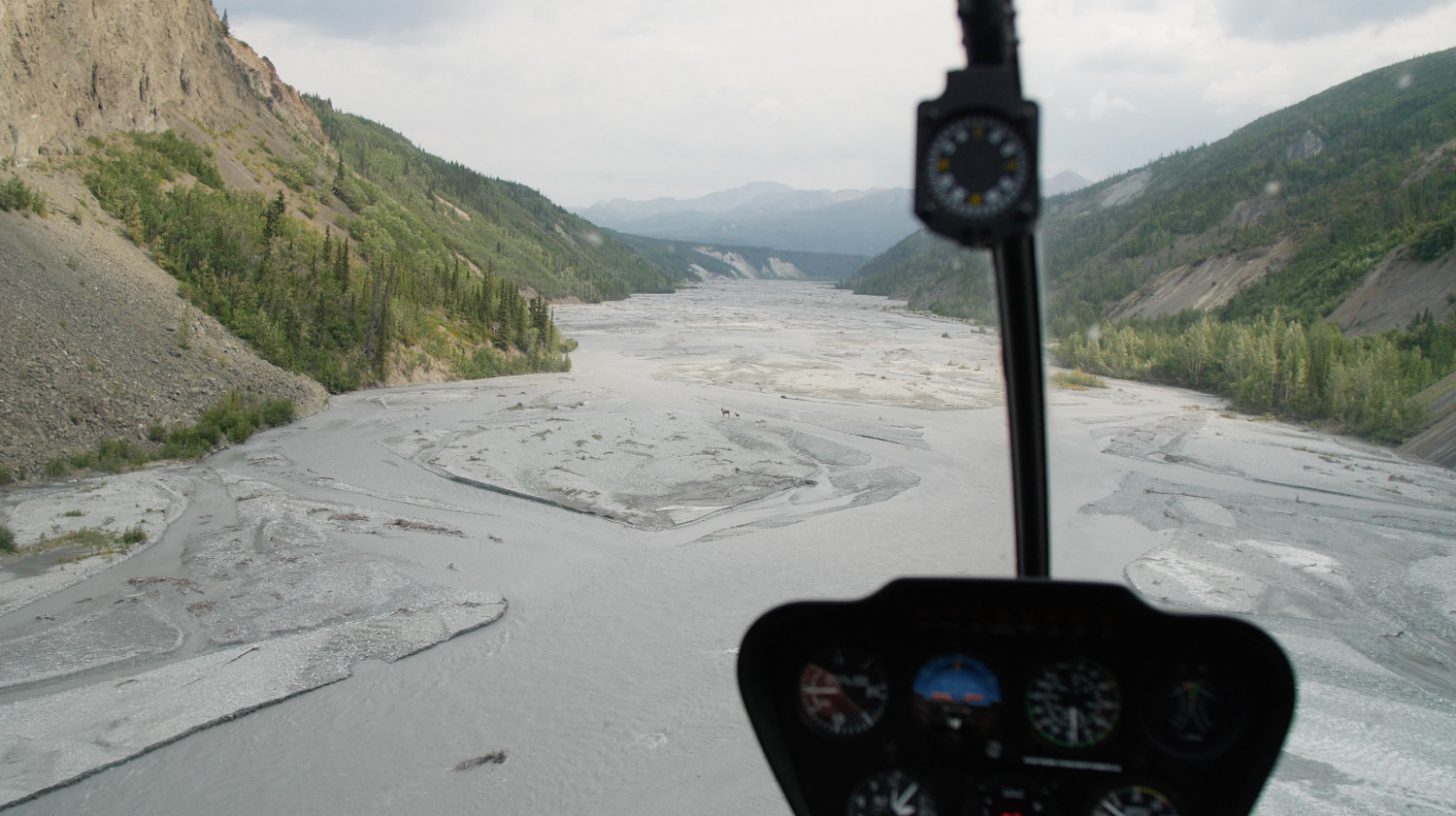 looking out helicopter window over Alaska river